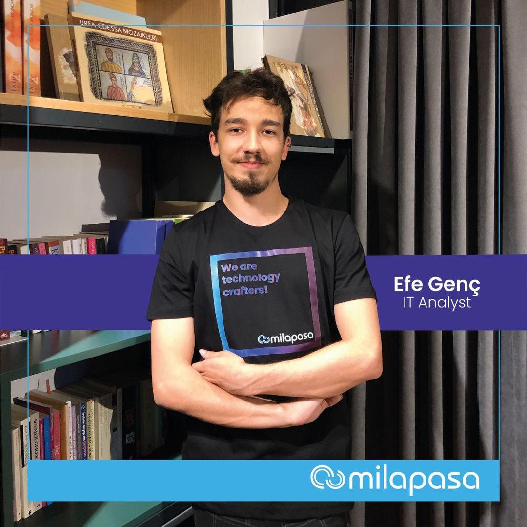 Milapasa's staff welcome card: a photograph of me standing in front of an office bookshelf in a company T-shirt, with a purple band across the lower third naming me and giving the title IT Analyst, and the Milapasa wordmark beneath it